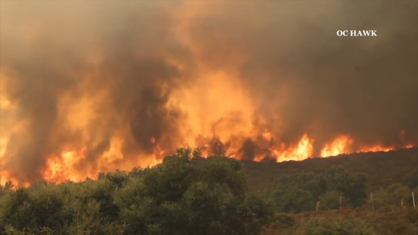 Firefighters battle the Airport Fire in Orange County.