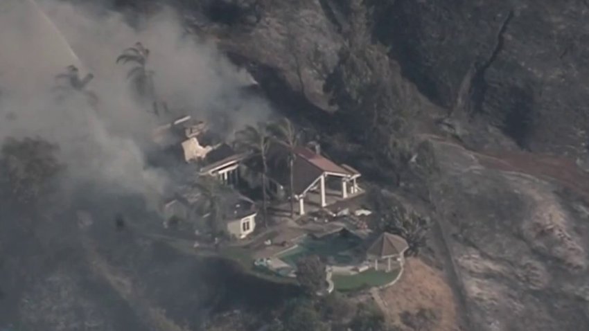 A wildfire burns homes Sunday July 21, 2024 in the Riverside area.